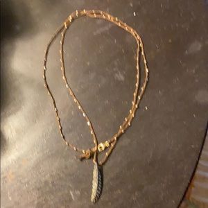 Diamond leaf necklace on brown silk cord